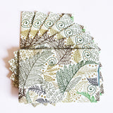 A stack of Tradevia RFID Blocking Package of Credit Card Sleeves with leaves on them, designed for RFID blocking to prevent skimming attacks.