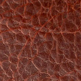 A close-up image of a Tradevia American Bison leather checkbook cover texture.