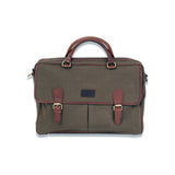 A green waxed canvas laptop bag from Tradevia with brown leather straps.
