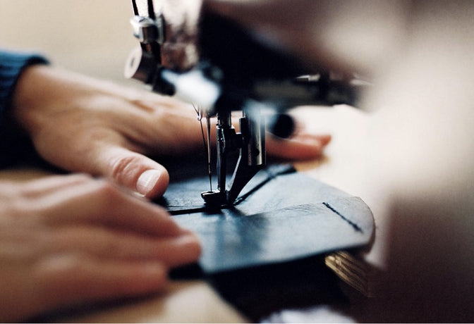 A person working on a sewing machine.