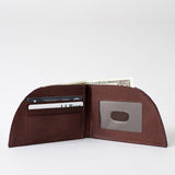 A brown leather Tradevia NON-RFID Made in Maine minimalist wallet with a credit card in it.