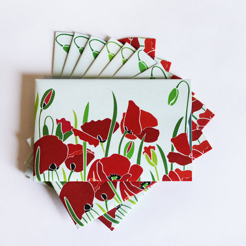 A stack of Tradevia RFID Blocking Package of Credit Card Sleeves with red poppies on them, designed for RFID blocking against skimming attacks.