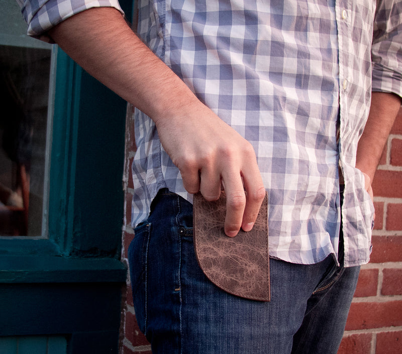A man holding a RFID-blocking Tradevia American Bison Leather Front Pocket Wallet in his front pocket.