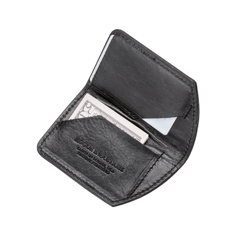 A slim, black leather Tradevia Minimalist Wallet with a credit card in it.