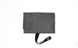 The LEATHER TECH ORGANIZERS - BLACK BISON by Tradevia is elegantly displayed against a white background, featuring bison leather with a strap and snap button closure.