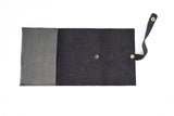 Introducing the LEATHER TECH ORGANIZERS - BLACK BISON by Tradevia: This sophisticated wallet is crafted from luxurious black bison leather and features an open design that reveals its organized interior. Equipped with a strap and snap button closure on the right side, it's perfect for neatly storing essentials such as cards and cord holders.