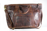 A brown full-grain leather Rockport weekend tote bag by Tradevia on a white background.