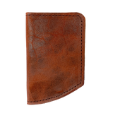 A slim brown leather Tradevia Minimalist Wallet on a black background.