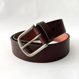 A handmade Baxter Leather Belt - 1.5" Wide in brown cowhide leather with a silver buckle by Tradevia.