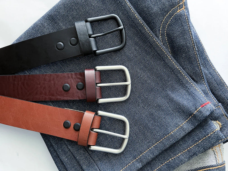 Three premium Baxter Belts from Tradevia on a pair of jeans.