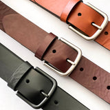 Four different colors of Chamberlain Leather Belts - 1.25" Wide by Tradevia on a white surface.