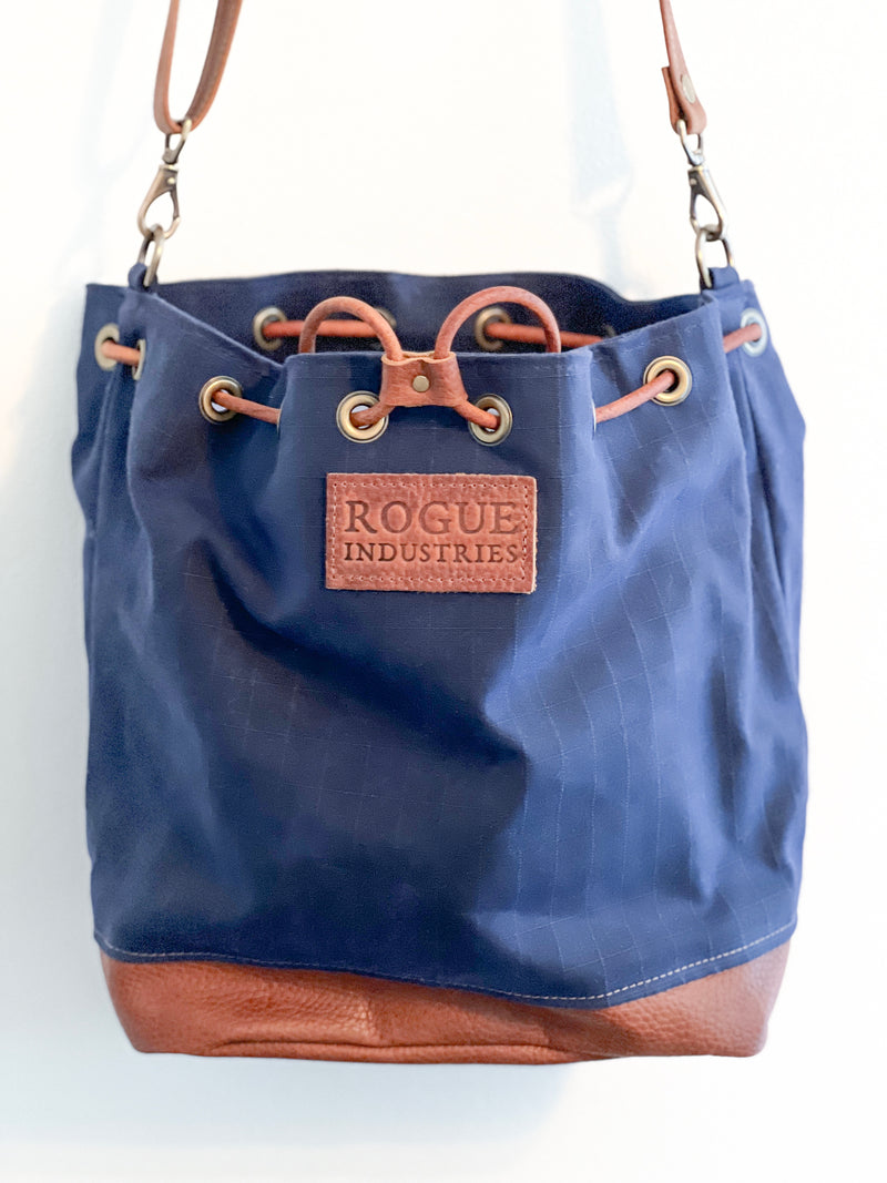 The Tradevia Kennebunkport bucket bag hanging on a wall.