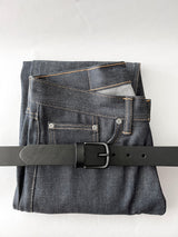 A pair of jeans with a Tradevia Chamberlain Leather Belt - 1.25" Wide.