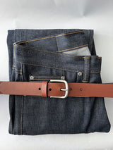 A pair of jeans with a Tradevia Chamberlain Leather Belt - 1.25" Wide.