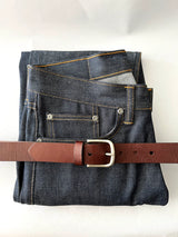 A pair of jeans with a Tradevia Chamberlain Belt and Minimalist Wallet Bundle.