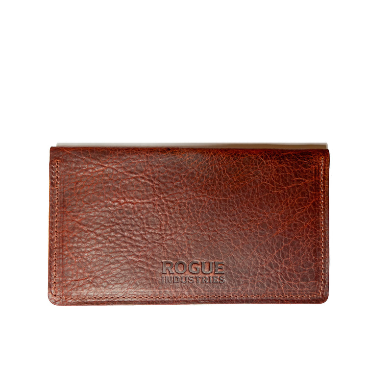 A brown American Bison leather checkbook cover with the word "focus" on it, crafted in a Maine workshop by Tradevia.
