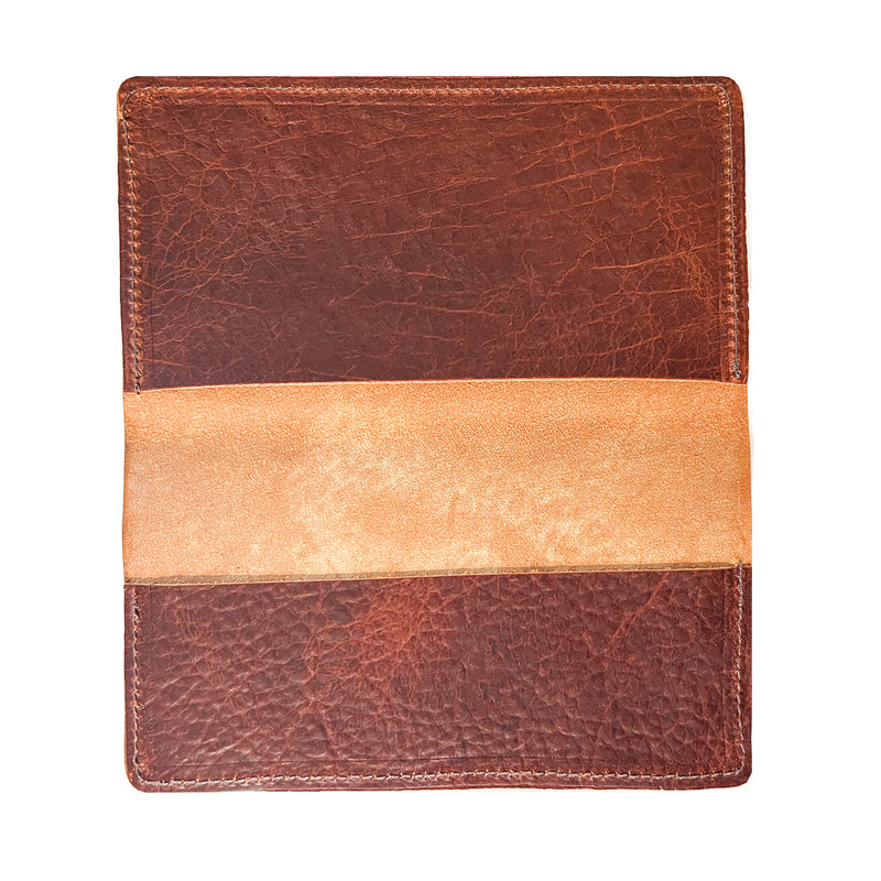 A brown and tan Tradevia American Bison leather checkbook cover on a white background, crafted in a Maine workshop.