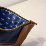 A blue and white leather pouch with a deer on it.
Product Name: Eastport Clutch
Brand Name: Tradevia

A Tradevia Eastport Clutch with a deer on it.
