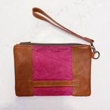 A tan and pink Tradevia Eastport Clutch with a strap.