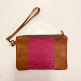 A tan and pink Eastport Clutch by Tradevia with a zipper.