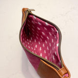 The inside of a pink and tan waxed canvas Eastport Clutch cosmetic bag by Tradevia.