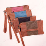 Four different colored Eastport Clutches by Tradevia on a white surface.