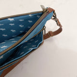 A blue Ellis River crossbody bag with a deer print on it by Tradevia.