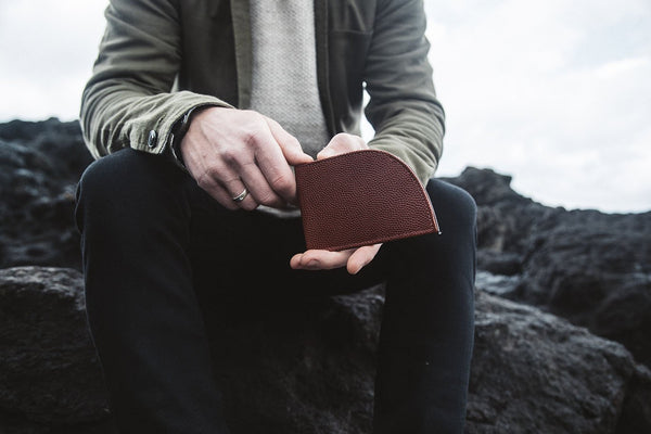 A person holding a Tradevia RFID-blocking Football Leather Front Pocket Wallet.