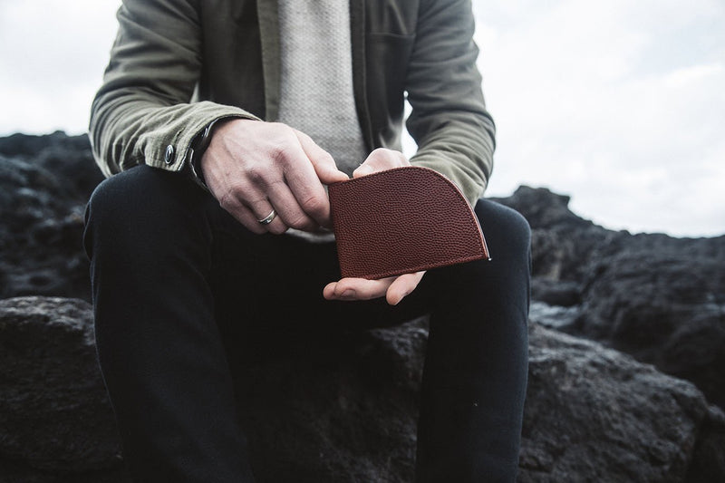 A person holding a Tradevia RFID-blocking Football Leather Front Pocket Wallet.