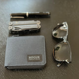 Tradevia Nylon Zip Around Wallet with sunglasses and a pen on a table, featuring an RFID blocking mechanism.