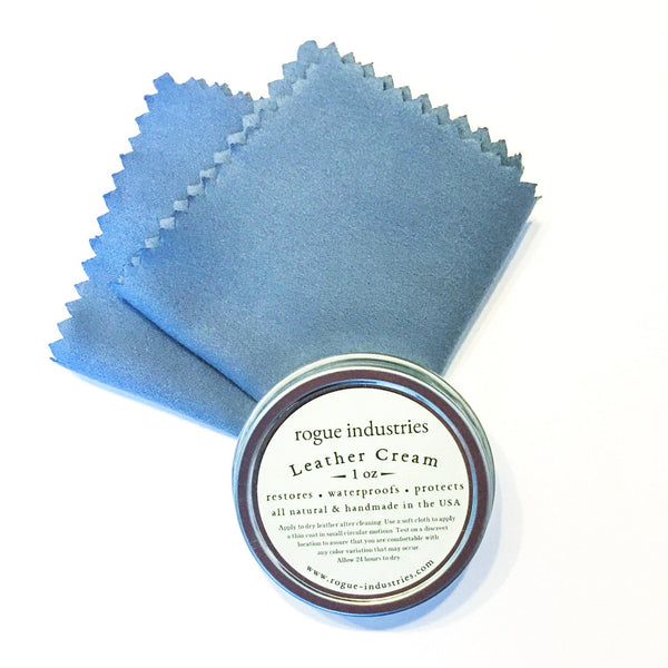 A blue cloth next to a tin of Tradevia All Natural Leather Cream.
