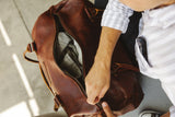 A brown Tradevia Mount Blue Leather Duffle bag.