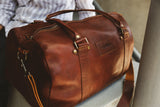 A premium Mount Blue leather duffel bag sitting on a ledge by Tradevia.