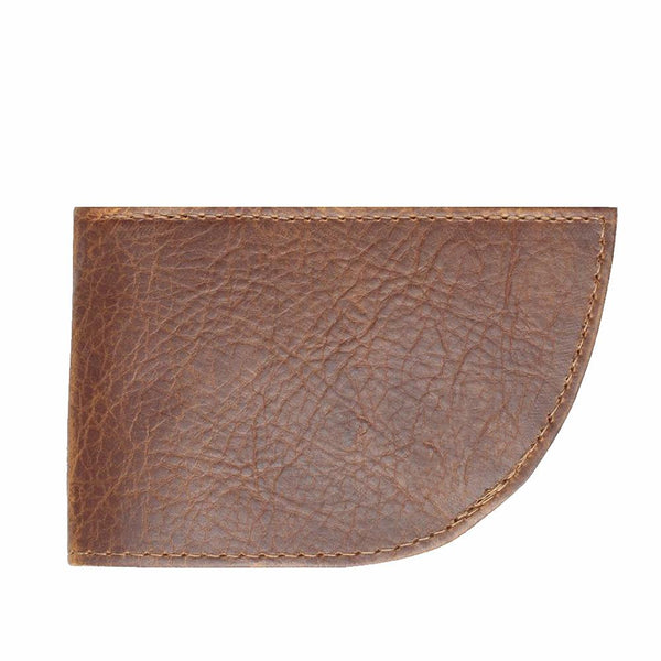 A slim brown leather wallet from Tradevia, known as the Factory Second PREVIOUSLY EMBOSSED Made in Maine Front Pocket Wallet - BROWN, features visible stitching and a slightly curved corner on the bottom right.