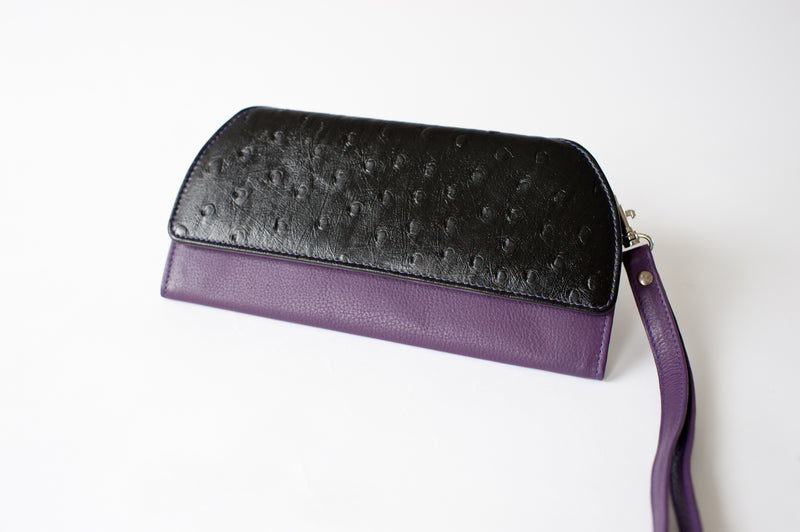 A black and purple leather RFID Blocking Clutch - Ostrich Print by Tradevia.