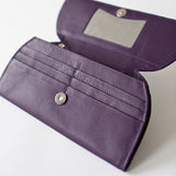 A purple leather RFID Blocking Clutch with a mirror and ostrich print from Tradevia.