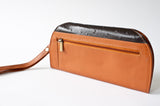 A brown and black leather RFID Blocking Clutch - Ostrich Print by Tradevia.