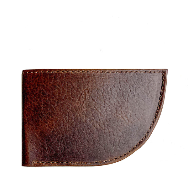 A Factory Second PREVIOUSLY EMBOSSED Made in Maine Front Pocket Wallet from Tradevia, featuring brown leather with stitching detail along the edges, a rounded bottom right corner, and RFID-blocking technology.