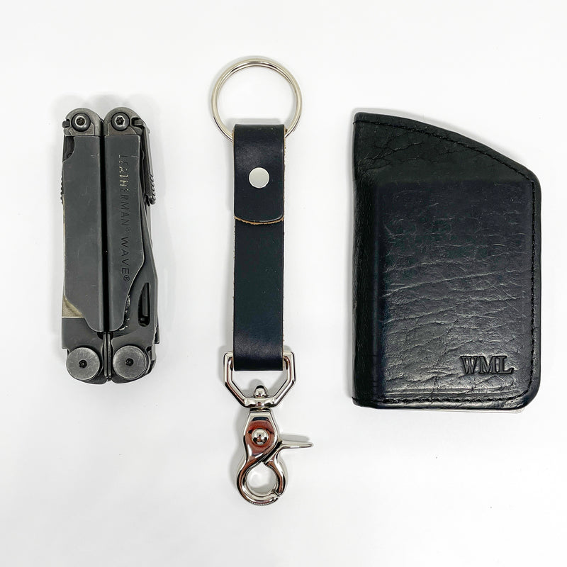 A durable Tradevia leather key chain with a nickel rivet and a pair of scissors.