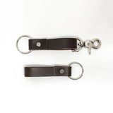 Two durable Tradevia brown leather keychains on a white background.