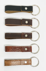 Four durable Tradevia leather key chains in different colors, each with a nickel rivet.
