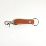 A tan Tradevia Leather Key Chain with a durable metal hook and nickel rivet.