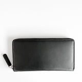 A black premium Leather Smartphone Clutch by Tradevia on a white surface.