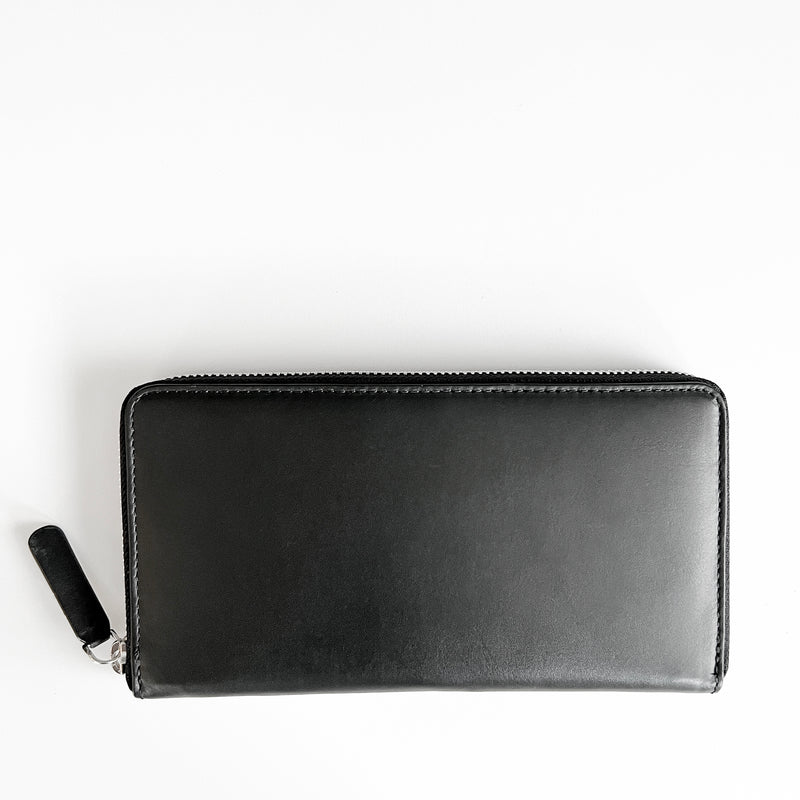 A black premium Leather Smartphone Clutch by Tradevia on a white surface.
