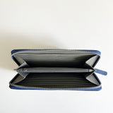 A blue zippered Leather Smartphone Clutch made of premium leather by Tradevia on a white surface.