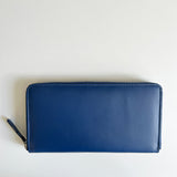 A blue premium leather smartphone clutch by Tradevia on a white surface.