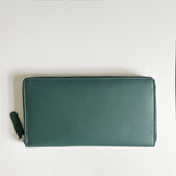 A green, premium leather Tradevia Leather Smartphone Clutch on a white surface.