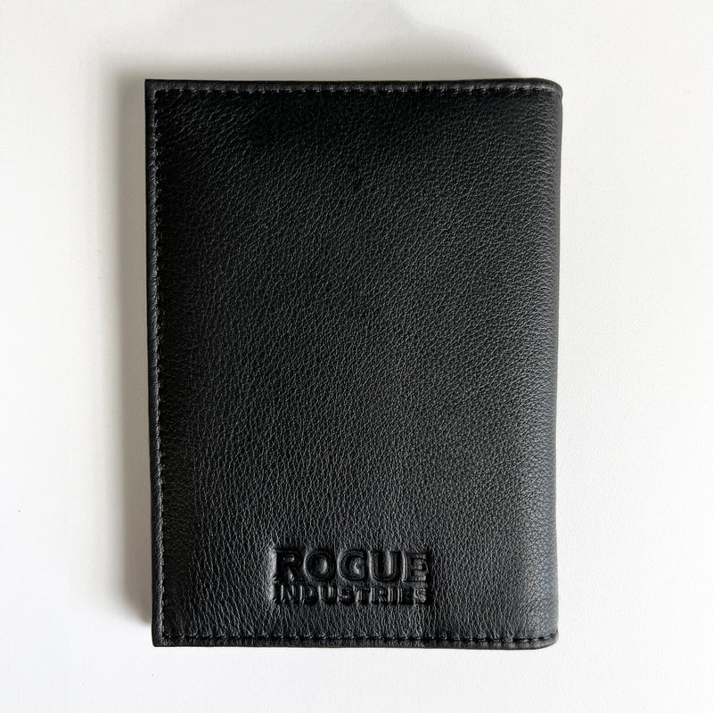 A black Tradevia Leather Passport Holder for travelers on a white surface.
