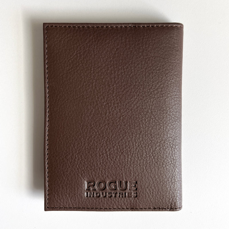 A Tradevia brown leather passport holder with the word "focus" monogrammed on it.