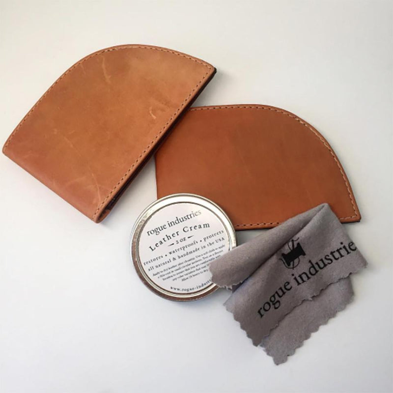 A tan leather wallet with a tin can of Tradevia All Natural Leather Cream and a cloth.
